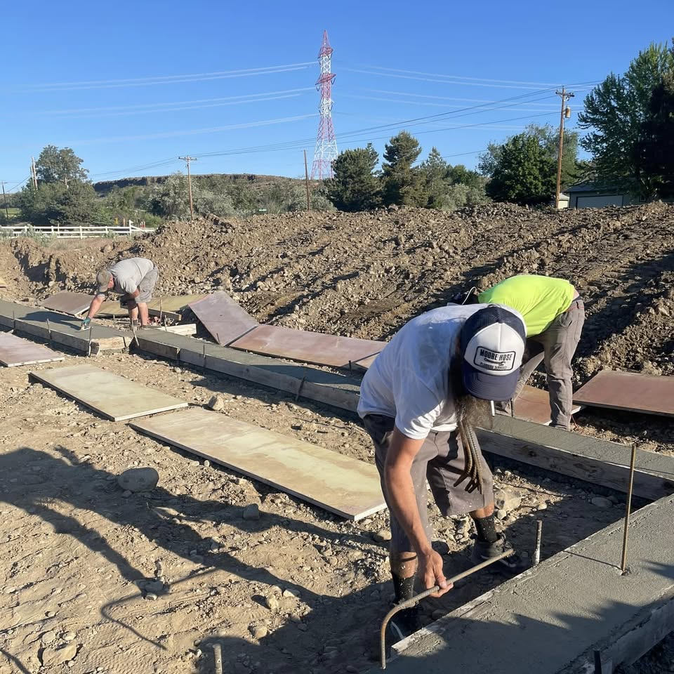 Crew finishing poured concrete flatwork